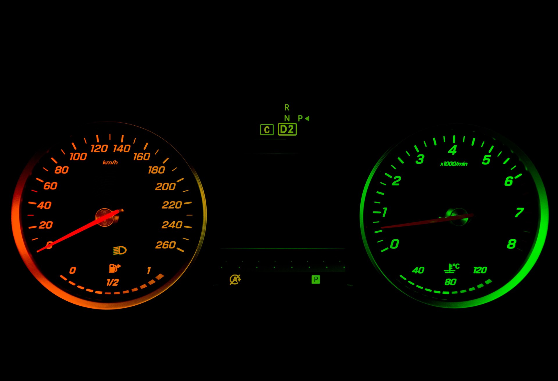 Close up shot of a tachometer in a car. Car dashboard. Dashboard details with indication lamps. Car instrument panel. Dashboard with speedometer, tachometer, odometer. Car detailing.